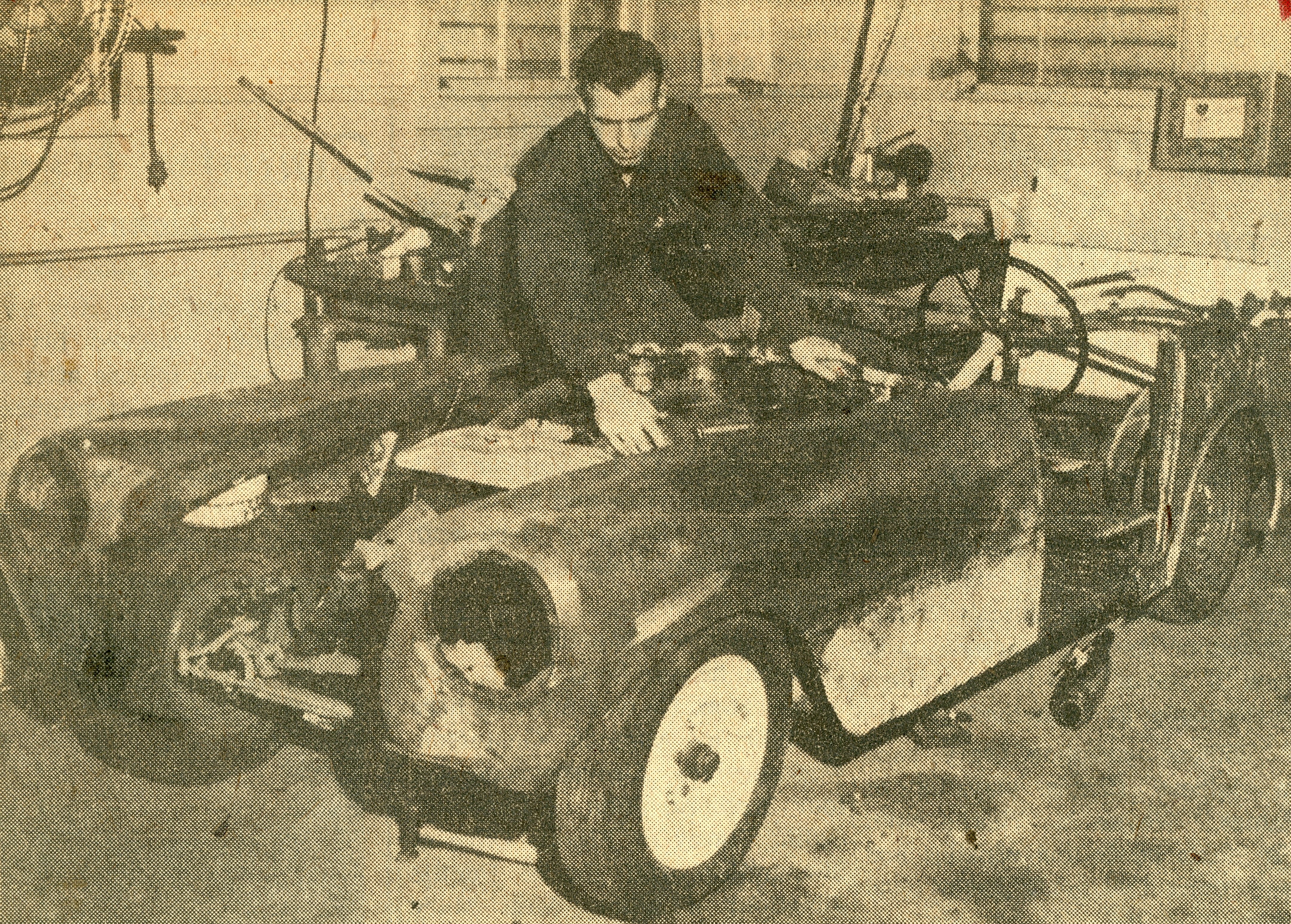 Photo of Alfred Clemens working on his custom-built sports car
