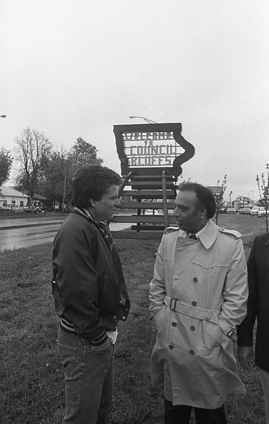 Jeff Brown and Raj Chopra chat in front of the Welcome to Council Bluffs sign on May 13, 1983