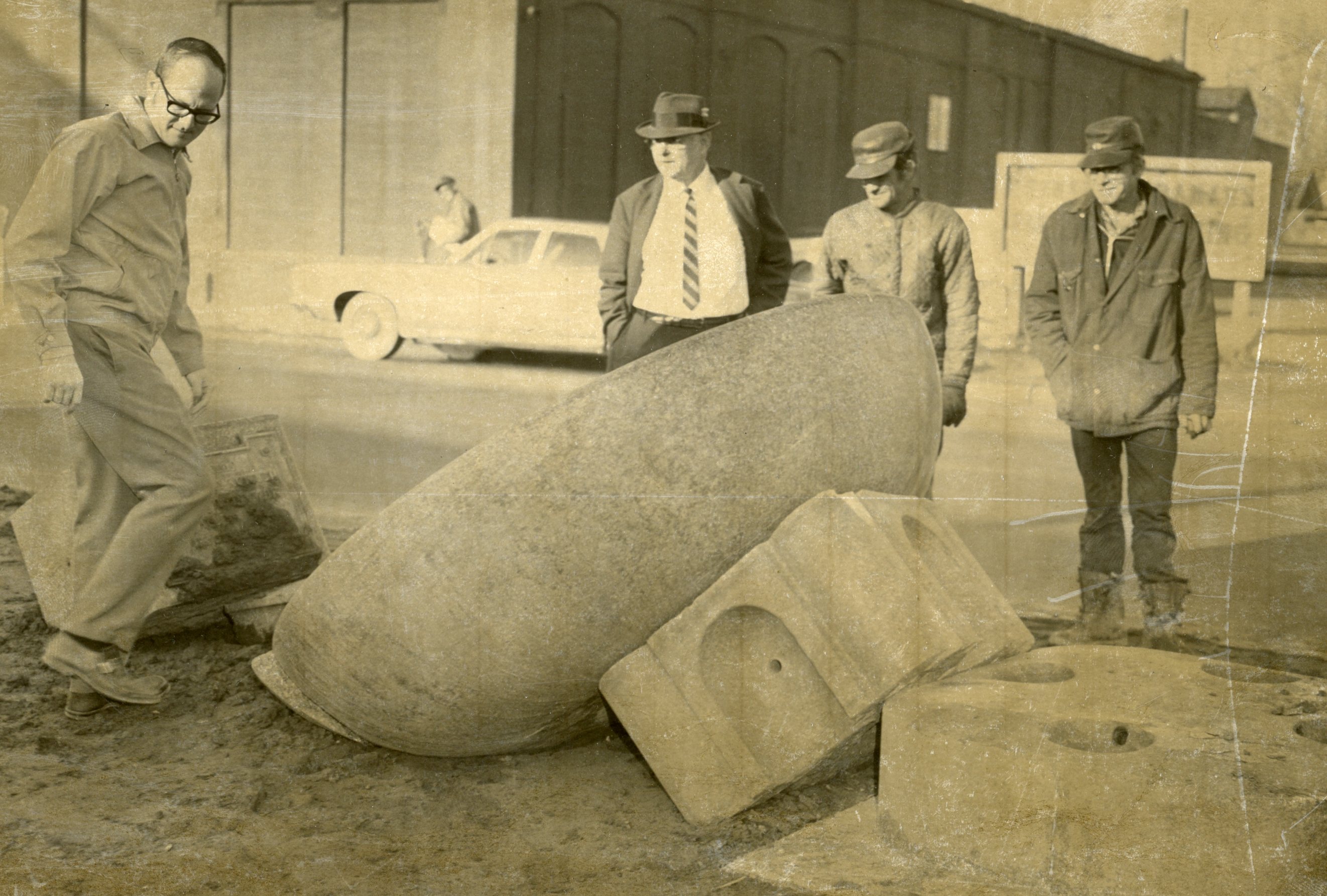 People inspect the water trough after it was struck by an automobile in March of 1971.