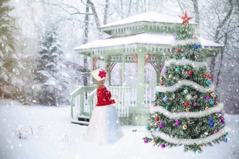 Winter scene with a gazebo, trees and a woman