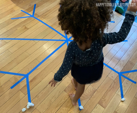 Child balancing on a snowflake line.