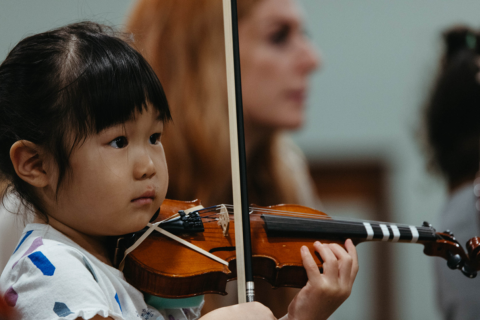 Child playing a violin.