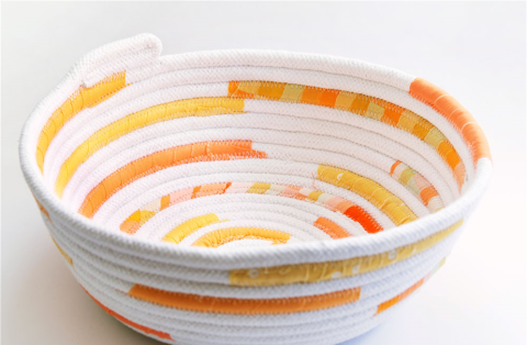 A bowl made out of rope and fabric scraps