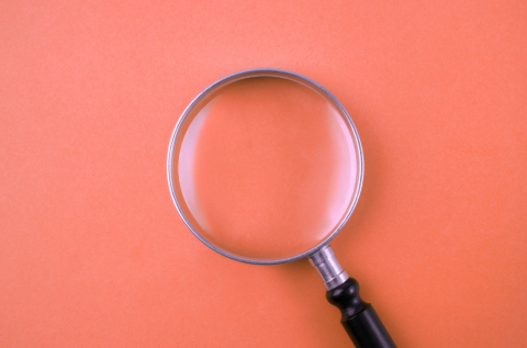 magnifying glass on red background