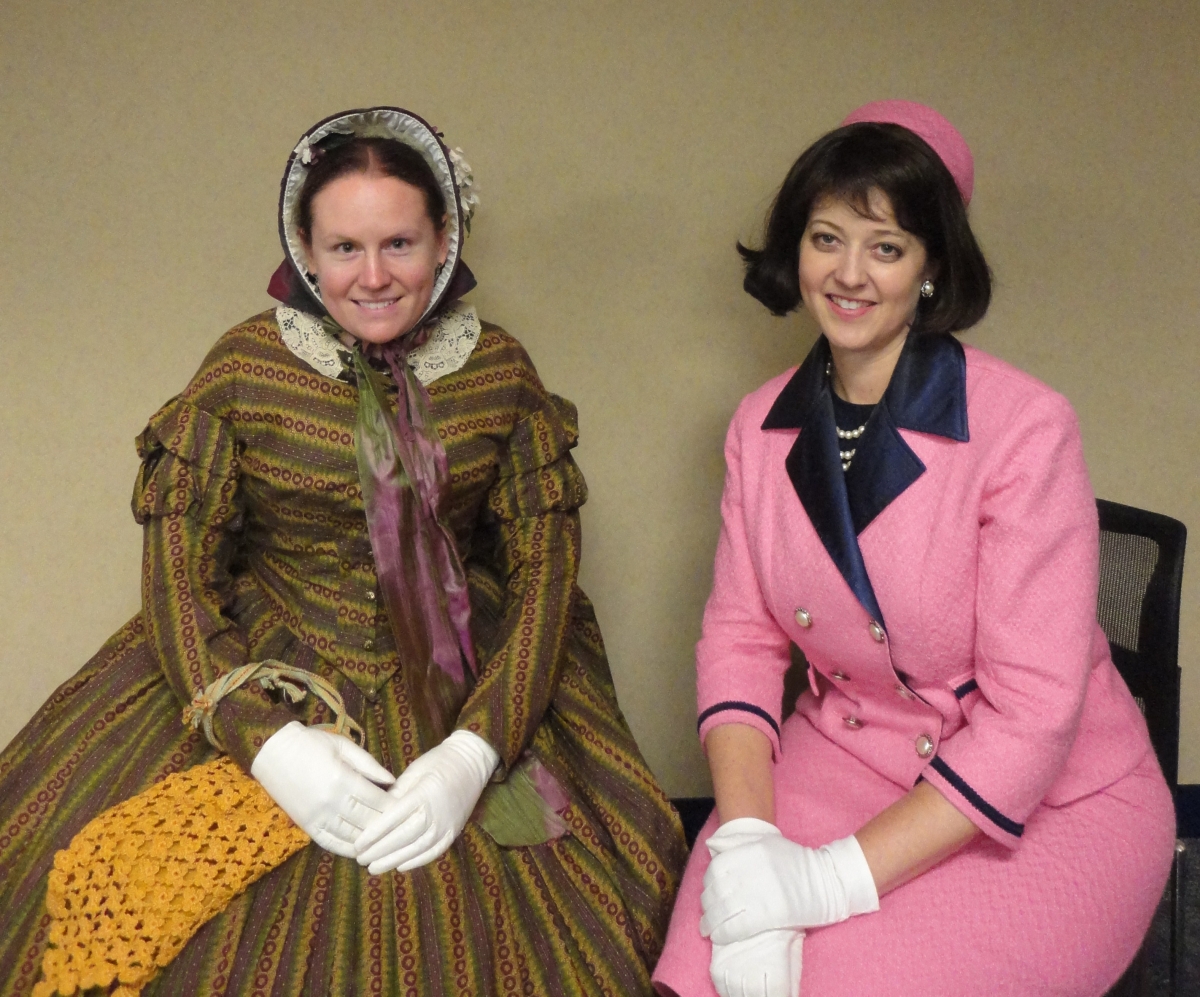 Laura Keyes as Mrs. Lincoln and Leslie Goddard as Mrs. Kennedy