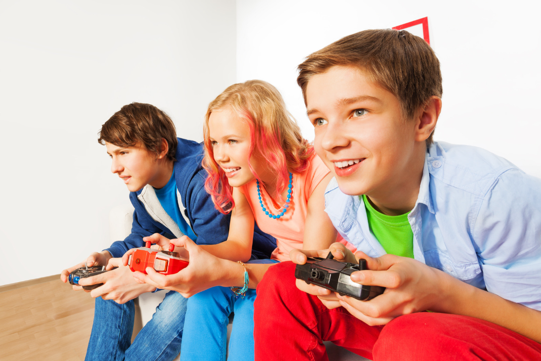 Three adolescents playing video games