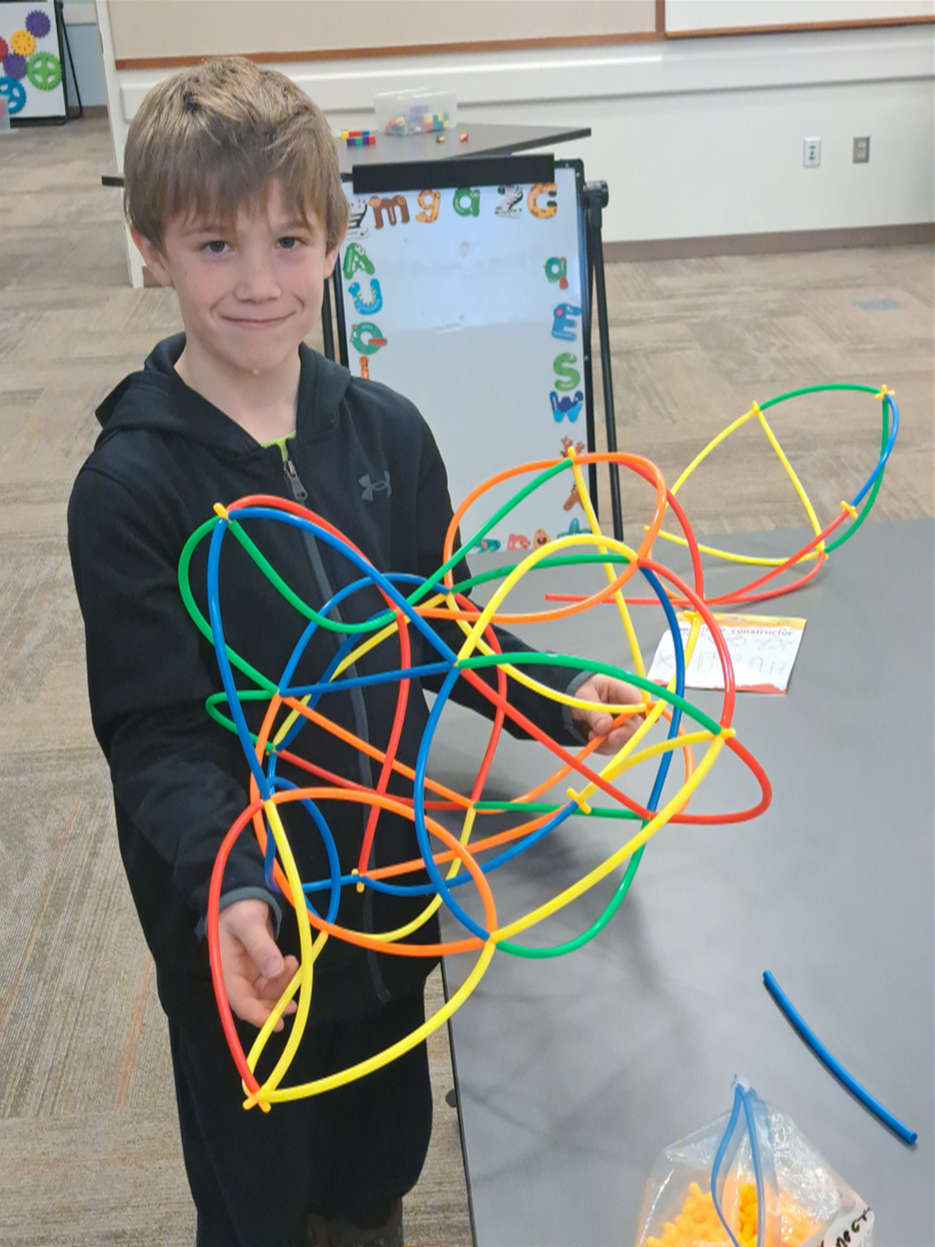 Boy playing with bendy straws